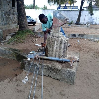 Village hand pump undergoing repairs 