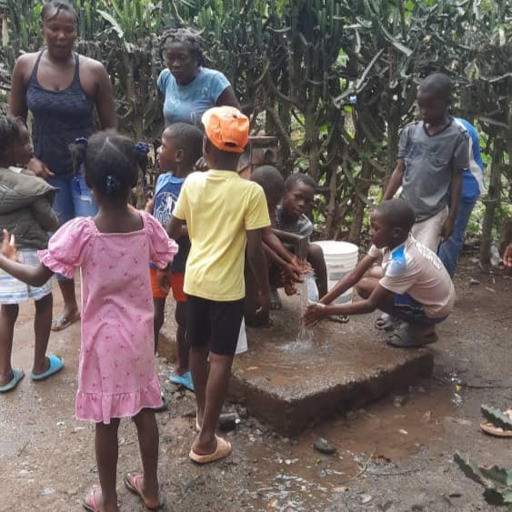 Children by newly repaired pump