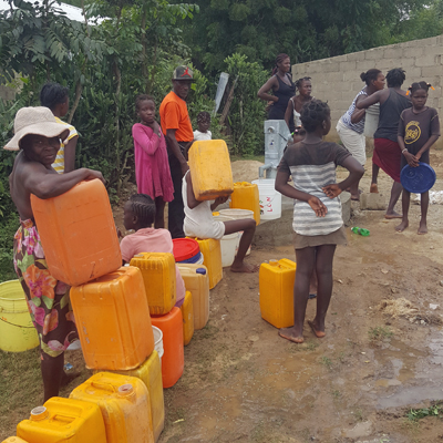 Lined up to fill many buckets with safe water!