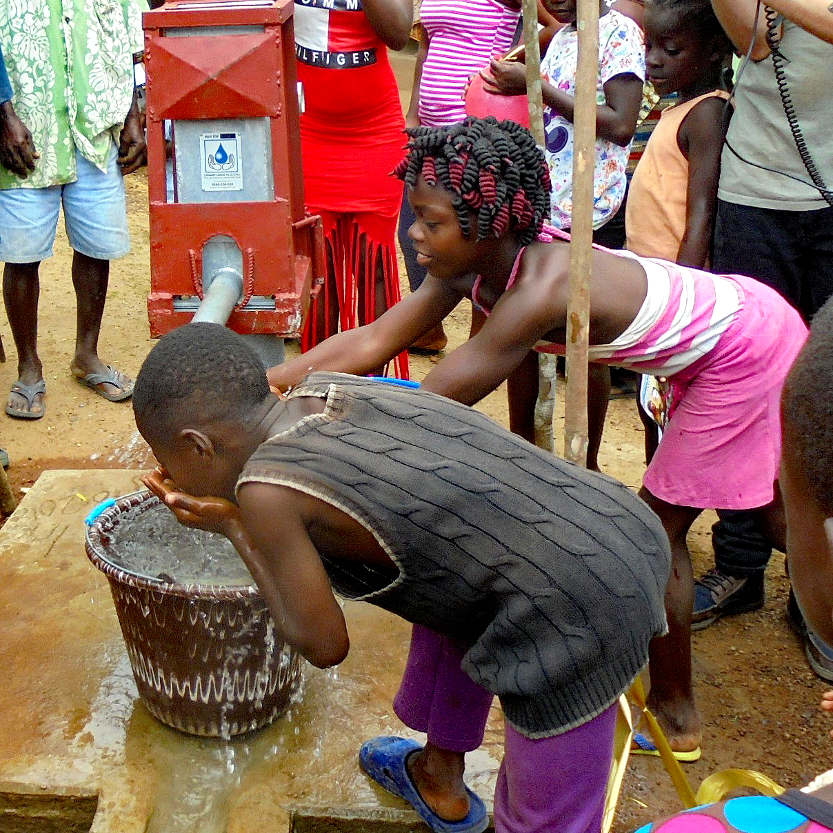 Children taking a drink of wonderful fresh water!