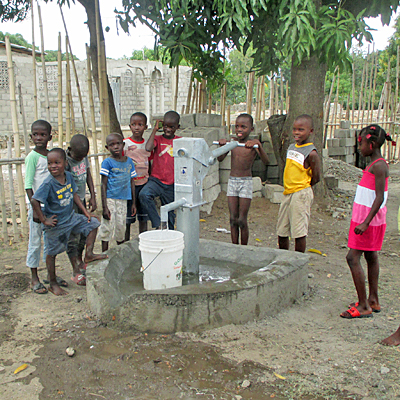 Children drawing water by new well 