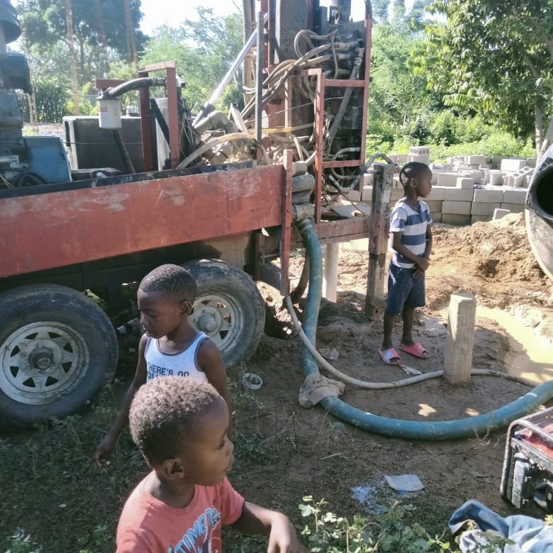 Children by rig (it is NOT actively drilling in this picture)