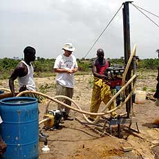 Jim training Liberian workers to build pads