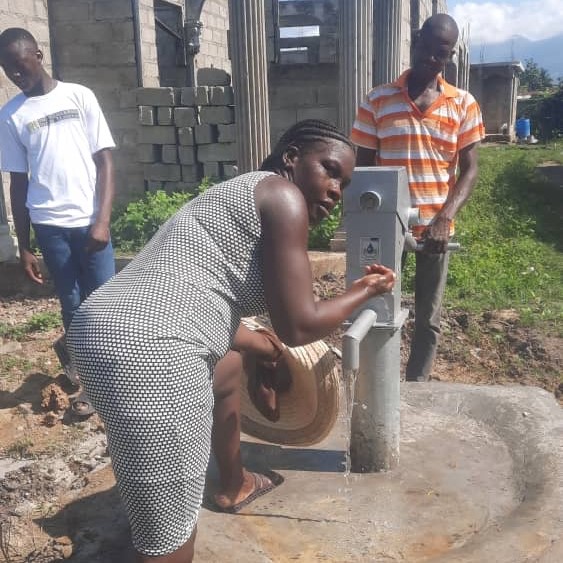 Villager drinking from New Well