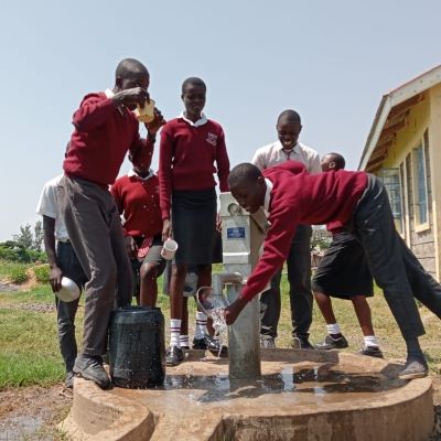 Students enjoying clean drinking water from their new well