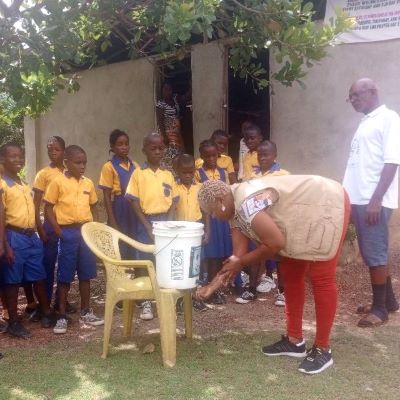 Demonstrating to villagers the right way to wash hands