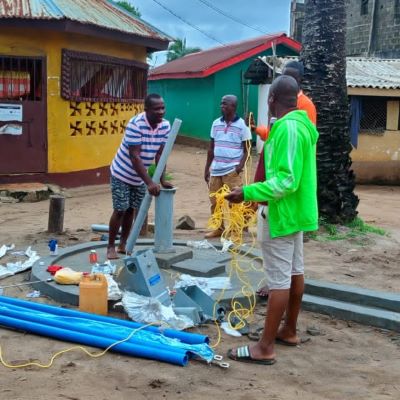 The team installing hand pump on a new well 