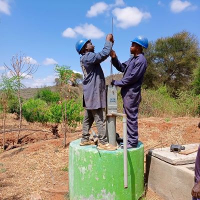 Hand pump repair team at work