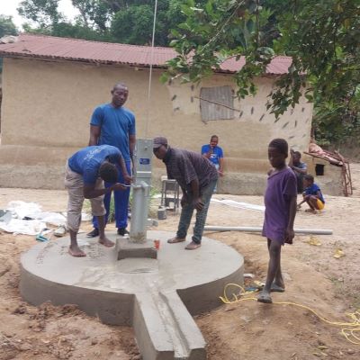 The team installing a hand pump on the village well