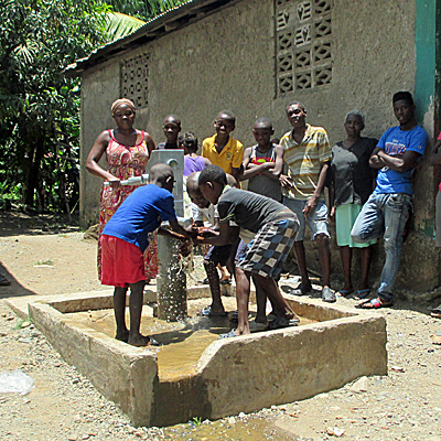 Children celebrating around newly Repaired Well