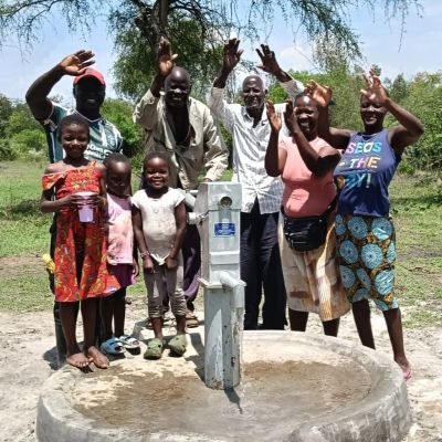 Happy villagers alongside their new well 