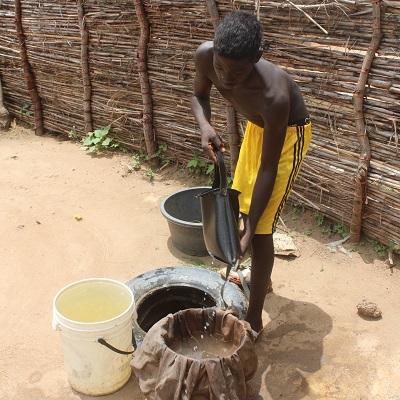 A boy filtering water 