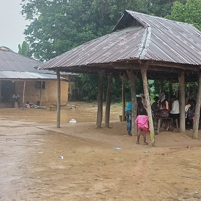 A happy village shelters from the rains
