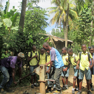 Children around well as it's being repaired