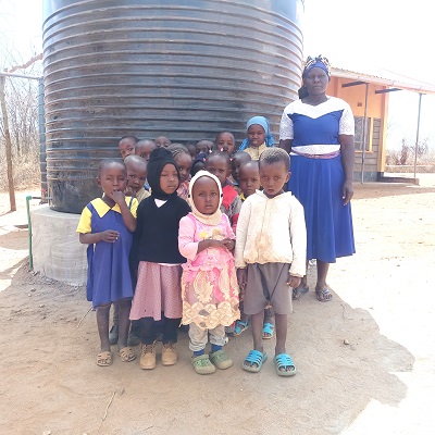 Students and their teacher at Kenzilu ECD