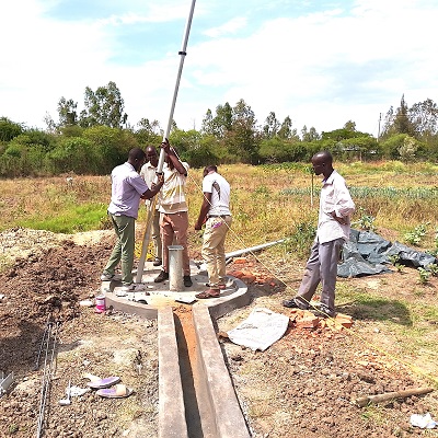 The team installing handpump in a new well