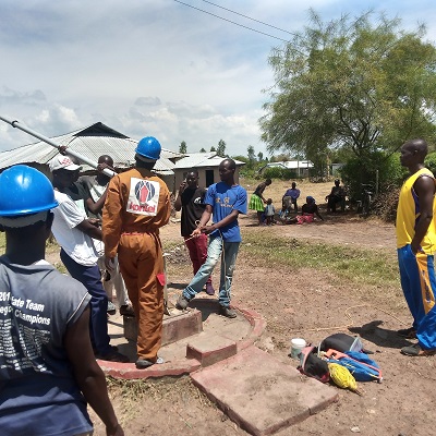 Our pump repair team replacing a hand pump at Otera community