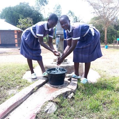 Students happy to access clean water after repair of the pump 