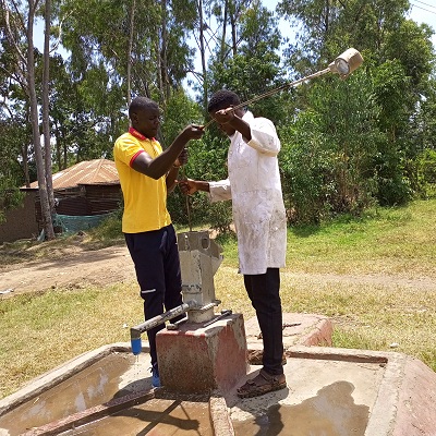 Our pump repair team working on a broken pump in Ofunyu community 