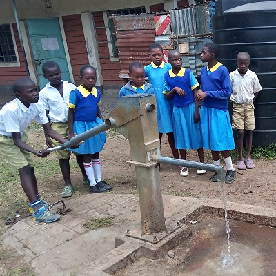 Students at Onong'no Primary School trying out a pump after repair
