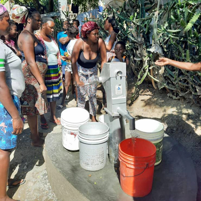 Women drawing Water from New Well