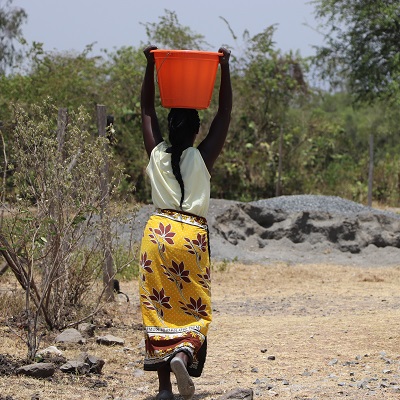 A villager taking home clean and safe water 