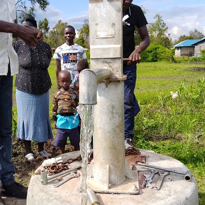 The hand-pump producing clean water after rehabilitation