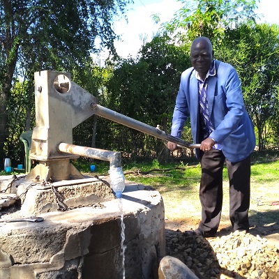 Communal hand-pump producing water after rehabilitation