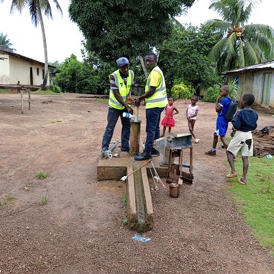 The communal hand-pump undergoing repair 