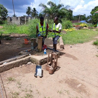 Hand-pump repair team at work.