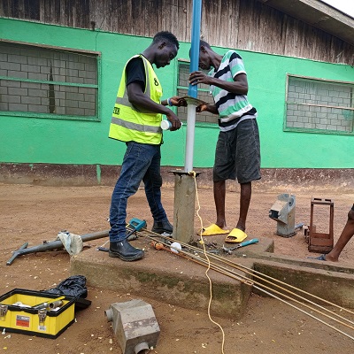Hand-pump repair team at work