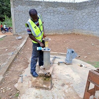 Hand-pump repair team at work