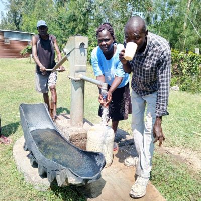 Villager enjoying clean drinking water