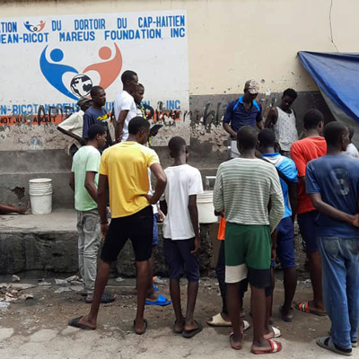 Gathering of villagers celebrating repaired well