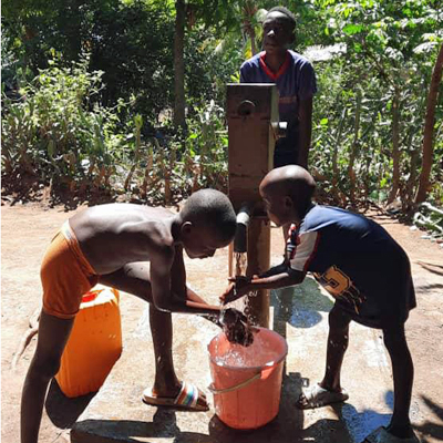 Children by newly repaired pump