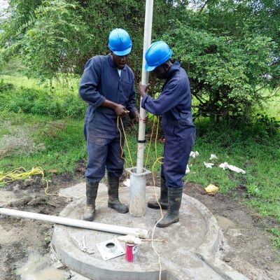 Hand pump installation in progress 