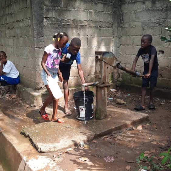 Children drawing water from Working pump