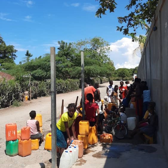 Many drawing water from newly repaired pump