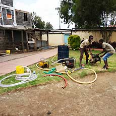 Young Orphans helping Test Repaired Pumps